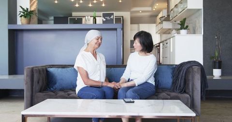 Senior and Friend Sharing Moments in Cozy Living Room