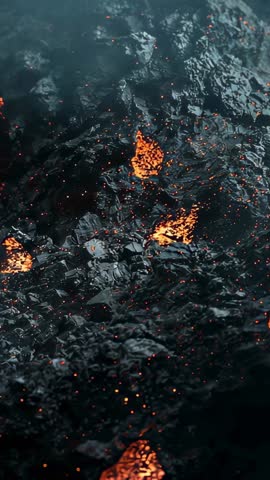 Vertical lava flow video panning over cooling basalt crust with flickering molten pools