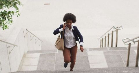Businesswoman Talking on Smartphone Walking Up Stairs - Download Free Stock Images Pikwizard.com