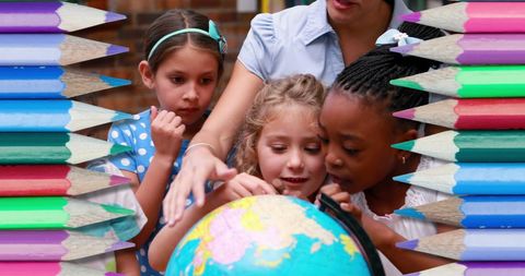 Diverse children exploring geography with globe in classroom setting
