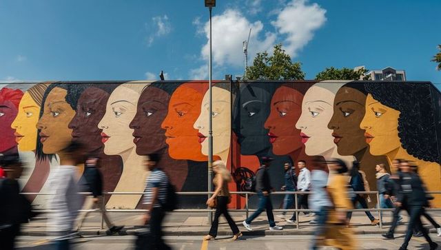 Diverse mural with pedestrians on urban street