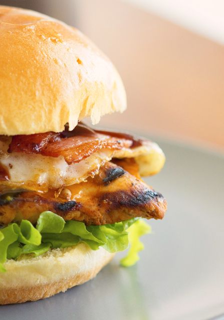 Close Up of Juicy Grilled Chicken Burger with Bacon and Lettuce - Download Free Stock Photos Pikwizard.com
