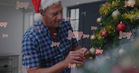 Cheerful Senior Man Decorating Christmas Tree with Santa Hat