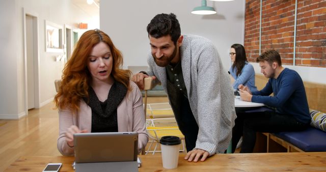 Colleagues Collaborating in Modern Office with Brick Wall - Download Free Stock Images Pikwizard.com