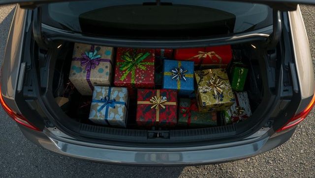 Car trunk filled with colorful holiday gift boxes