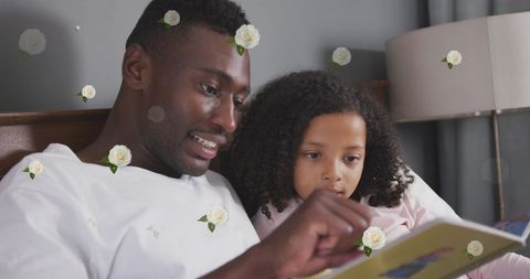 Father and Daughter Reading Book Together with Decorative Roses