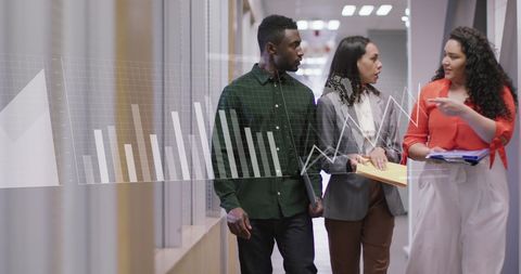 Diverse Colleagues Analyzing Data in Office Corridor