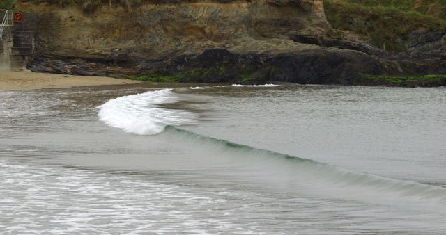 Gentle Ocean Wave Crashing onto Rocky Shoreline - Download Free Stock Images Pikwizard.com