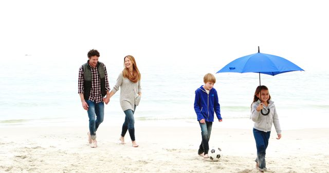 Happy family walking along the shore enjoying outdoor activities. Perfect for showcasing family-bonding time, holiday destinations, leisure and recreation, children's activities, advertising vacations, and promoting outdoor excursions.