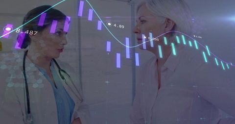 Female Physician and Mature Patient Reviewing Digital Charts