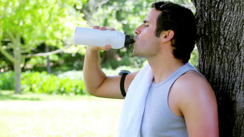 Athlete Rehydrating Outdoors After Warm Weather Run