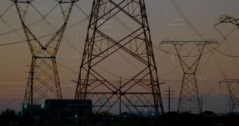 High voltage transmission towers against dusk sky with digital overlay