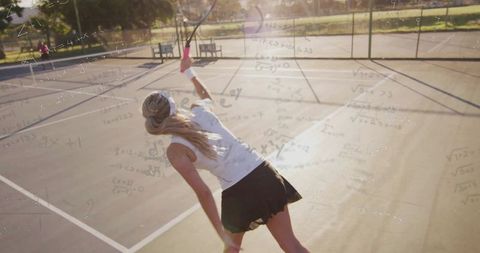 Tenacious Tennis Player in Action on Sunlit Court
