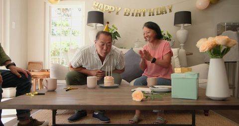 Diverse Seniors Celebrating Birthday With Cake and Gifts