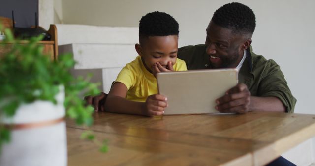 Father and Son Enjoying Time Together on Digital Tablet at Home - Download Free Stock Images Pikwizard.com