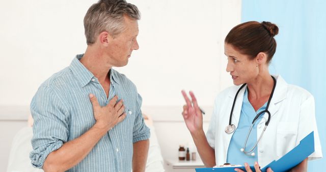 A mature male patient is seen discussing his health with a female doctor in a medical office setting. The doctor, wearing a white lab coat and stethoscope, appears to be giving advice or explaining treatment. This image could be used for healthcare articles, medical brochures, consultancy advertisements, or patient care guides.