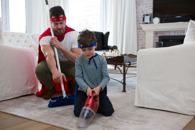 Father and son pretending to be superhero while cleaning floor