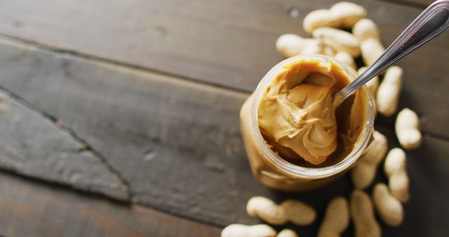 Creamy Peanut Butter in Jar with Peanuts on Wooden Surface - Download Free Stock Images Pikwizard.com