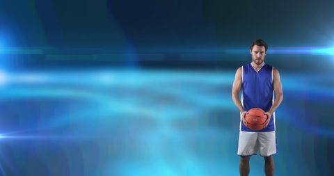 Basketball Player Holding Ball on Glowing Blue Background - Download Free Stock Images Pikwizard.com