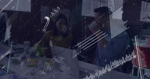 Colleagues collaborating over laptop with overlaid analytics charts and futuristic data HUD