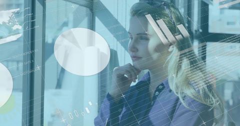 Businesswoman Analyzing Digital Financial Graphics in Modern Office