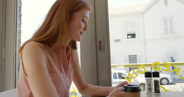 Young woman enjoying coffee in modern cafe - Download Free Stock Images Pikwizard.com