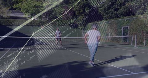 Active tennis players swapping volleys on private outdoor court