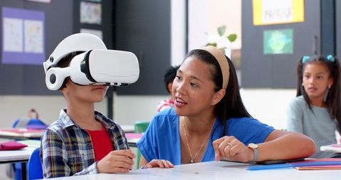 Teacher Guiding Student with VR Headset for Interactive Learning