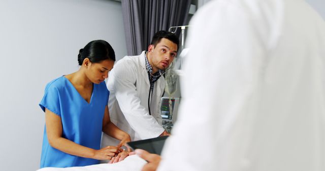 Medical Professionals Attending to Patient in Hospital Room - Download Free Stock Images Pikwizard.com