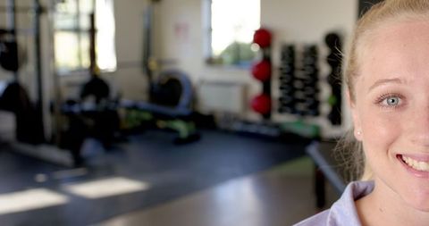 Smiling Woman in Rehabilitation Gym Embracing Fitness Journey