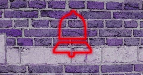 Glowing red neon bell on vibrant purple brick wall