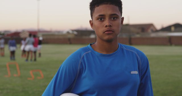 Focused Young Soccer Player Holding Ball During Outdoor Practice - Download Free Stock Images Pikwizard.com