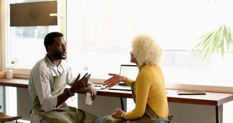 Barista Team Engaging in Conversation at Trendy Coffee Shop