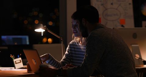 Creative Team Collaborating On Project in Dimly Lit Office - Download Free Stock Images Pikwizard.com