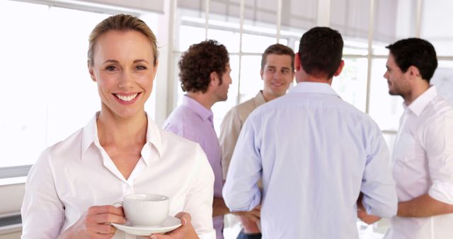 Confident Businesswoman Enjoying Coffee Break with Colleagues - Download Free Stock Images Pikwizard.com