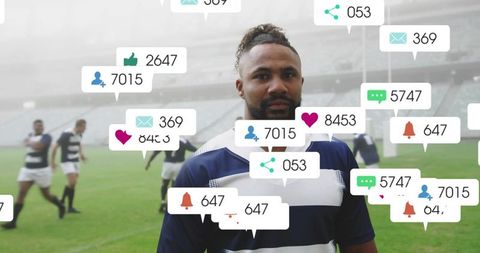 Standing rugby player receiving social media notifications overlay on stadium pitch