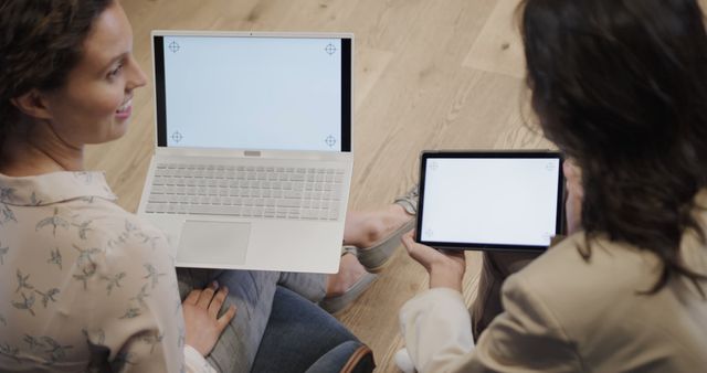 Two Women Sharing Digital Devices While Collaborating on Project - Download Free Stock Images Pikwizard.com