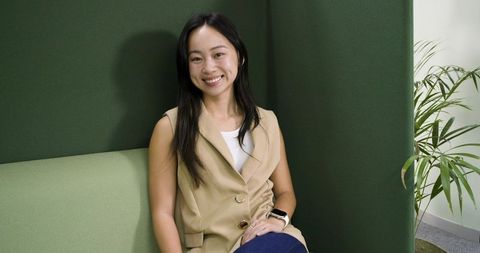 Asian professional sitting in eco-friendly lounge space