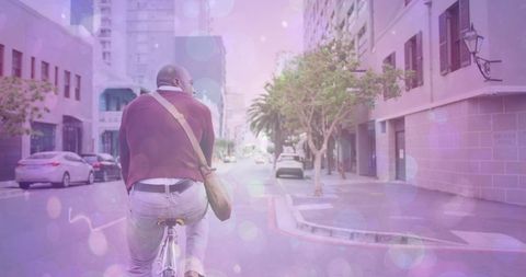 Rear View of African American Cycling Leisurely in Urban Setting