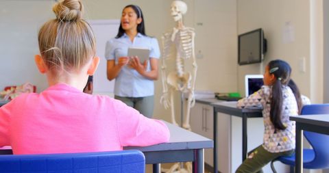 Teacher explaining human anatomy to students in classroom