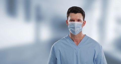 Young Doctor Wearing Mask in Hospital Background