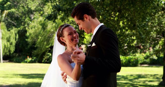 Smiling Bride and Groom Dancing Outdoors on Wedding Day - Download Free Stock Images Pikwizard.com