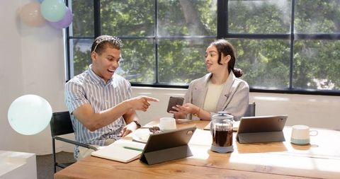 Business partners enjoying workplace birthday celebration