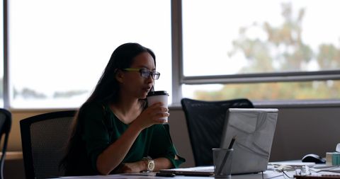 Focused Woman Working on Laptop with Coffee in Modern Office - Download Free Stock Images Pikwizard.com
