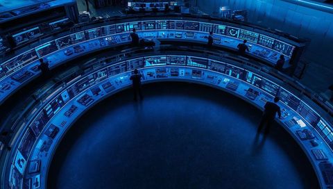 Mission Control Operators Monitoring Data in Futuristic Hub