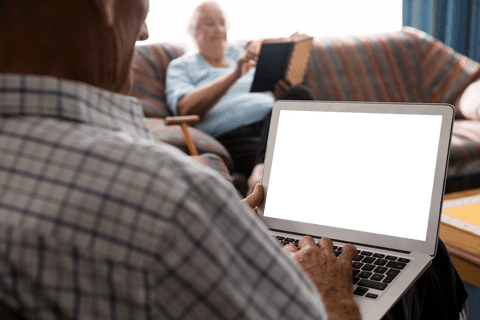 senior man using laptop with transparent screen in comfortable home - Download Free Stock Videos Pikwizard.com