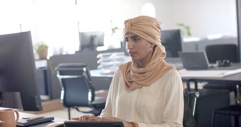 Focused Businesswoman Typing in Modern Office Space