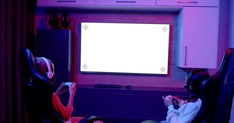 Teenage Girls Gaming in Cozy Room with Neon Lights