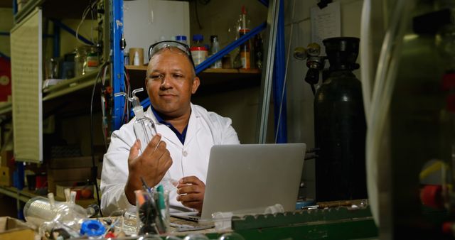 Scientist working in a laboratory analyzing data from experiments on a laptop. Ideal for illustrating scientific research, laboratory settings, and technological advancements in science. Useful for educational materials, training resources, and industry-related content.