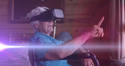Senior Woman in Wheelchair Engaging with Virtual Reality Technology